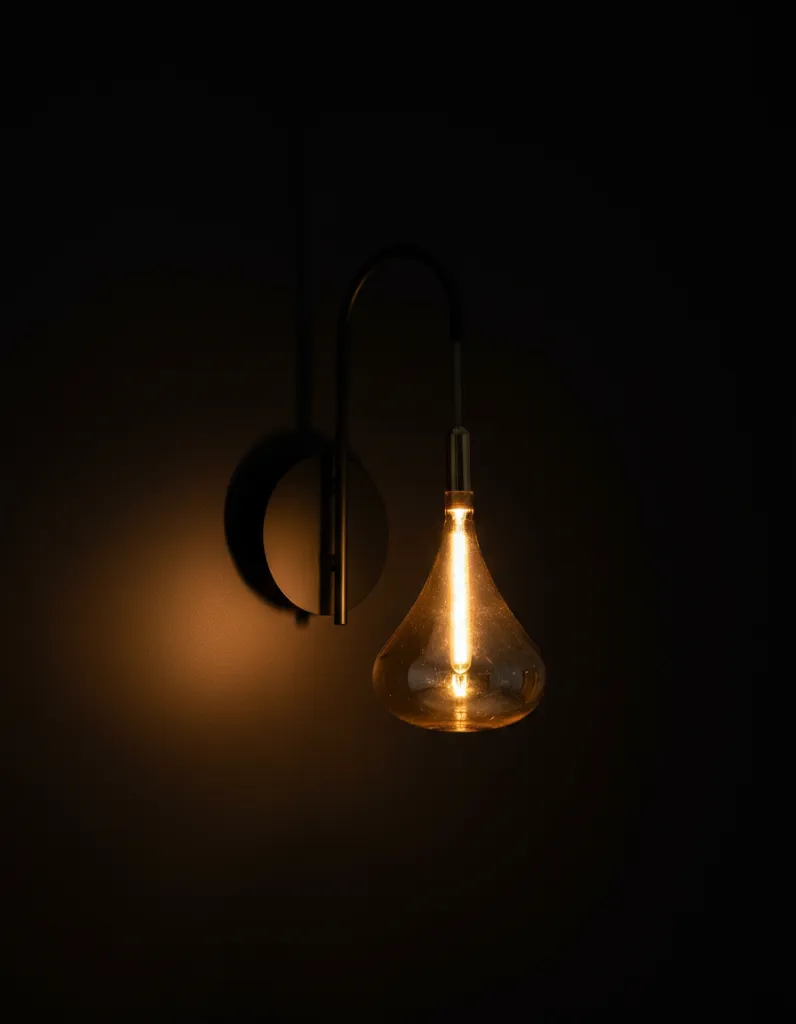 Amber-Glass-Wall-Light-Illuminated.webp